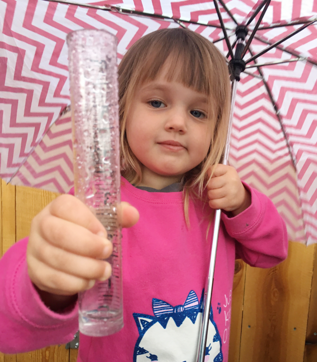 Child checking rain gauge - Morro Bay National Estuary Program